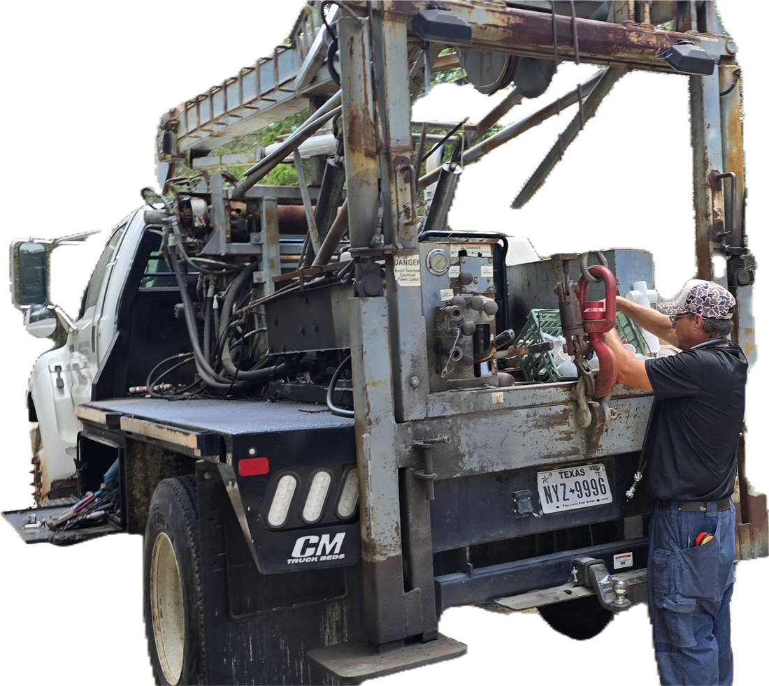 Royall's service rig on a Texas job site — the boom truck set up over a well while a technician hooks on the lifting swivel to pull pipe.